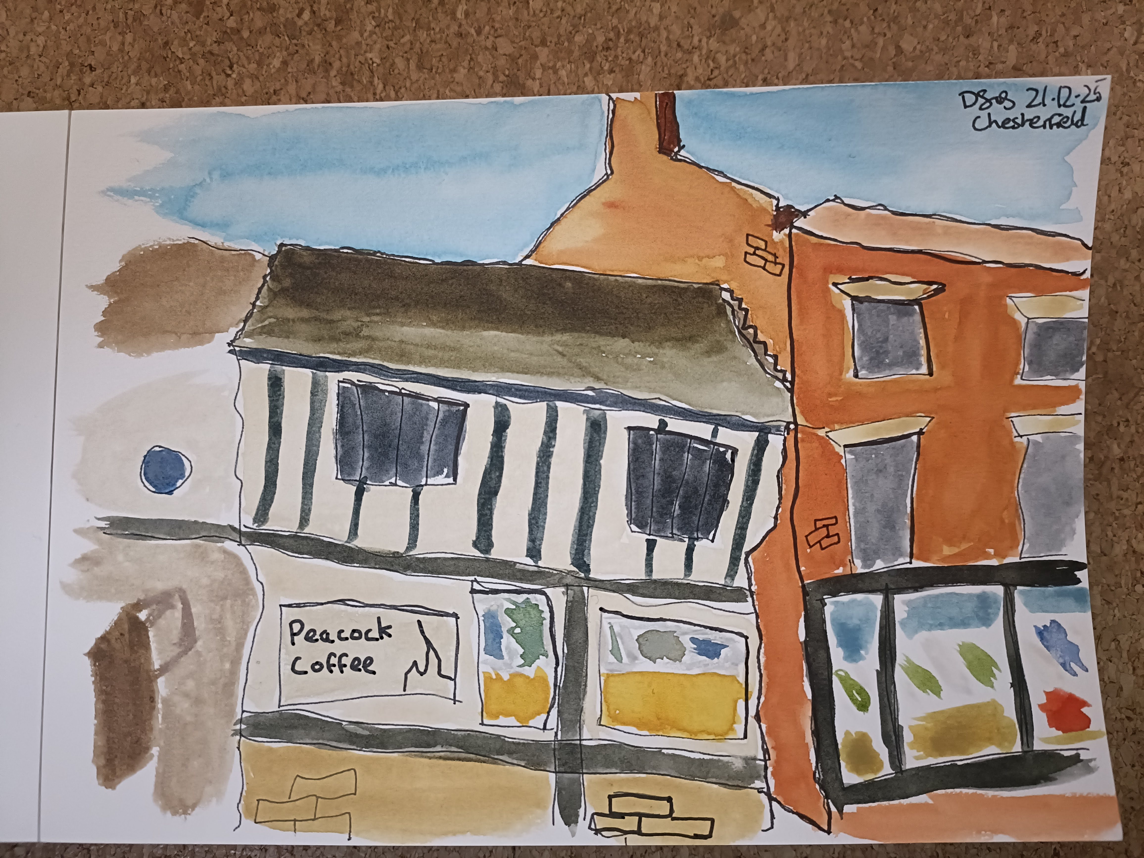 Watercolor painting of a building with a sign that reads 'Peacock Coffee' beside a red-brick structure, featuring a blue sky in the background.